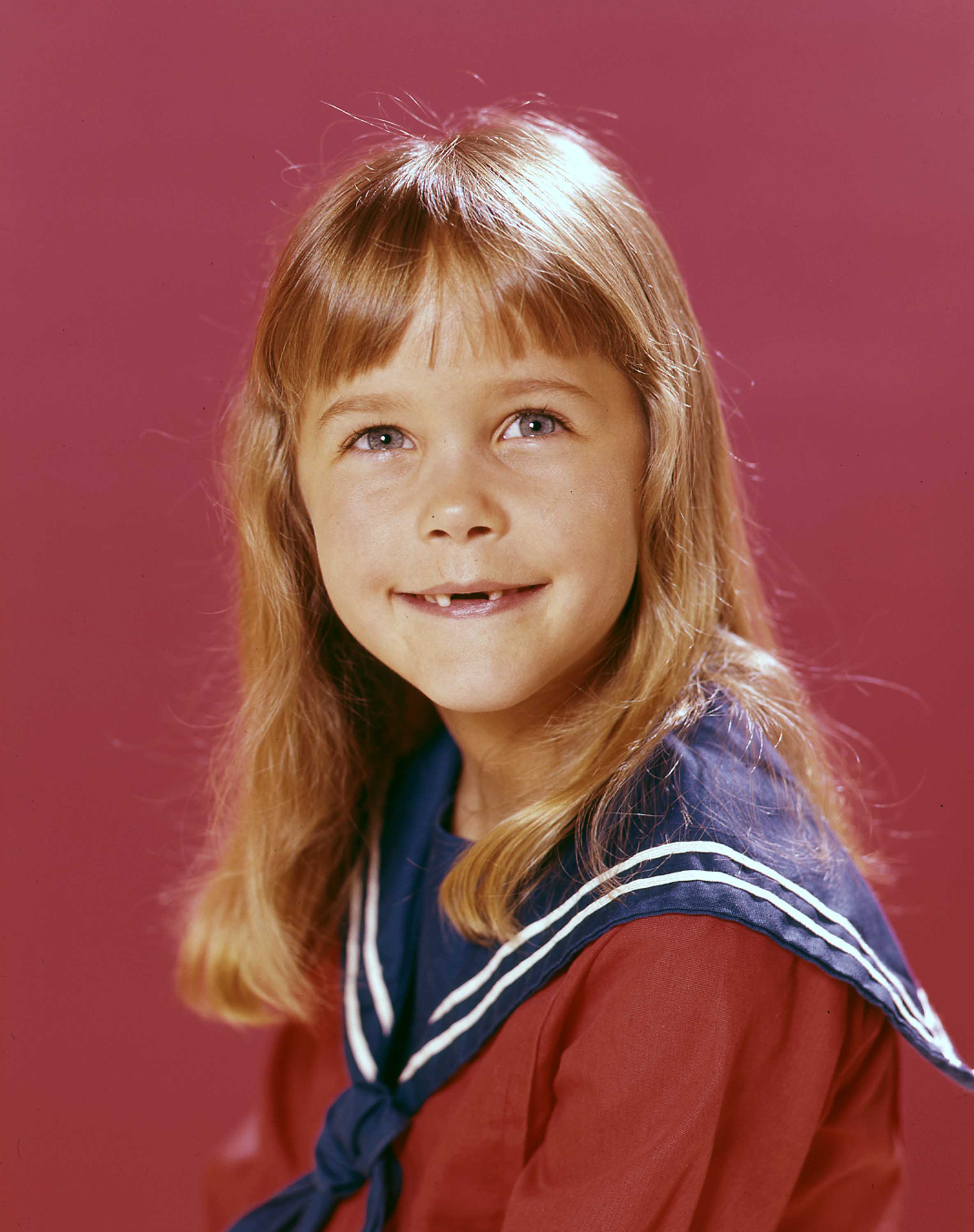 Murphy appears on her own in this childhood studio portrait, wearing her hair long with straight bangs against a red backdrop. By this stage, her face had become closely associated with Tabitha Stephens, providing another clear marker in the transformation fans are now tracing through her later photos.