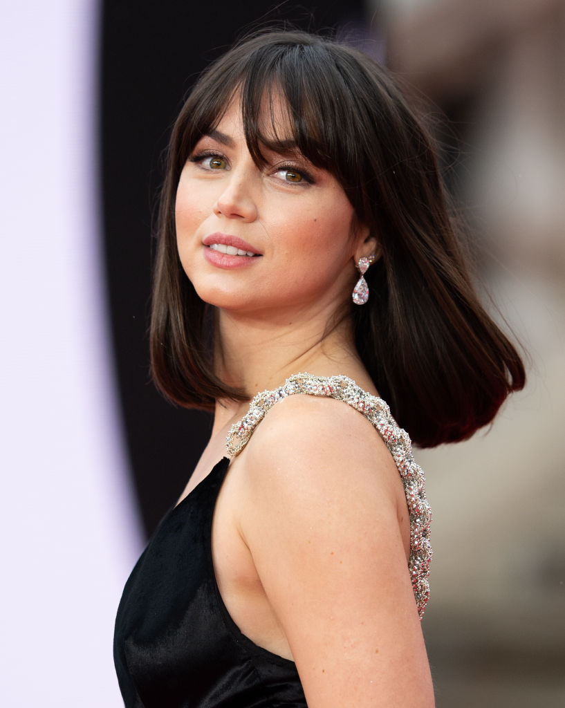 In a red carpet moment, Ana de Armas stunned in a sleeveless black gown that featured ornate, jeweled straps that caught the light beautifully. With her sleek shoulder-length hair, soft makeup, and teardrop diamond earrings, she exuded timeless glamour and sophistication.