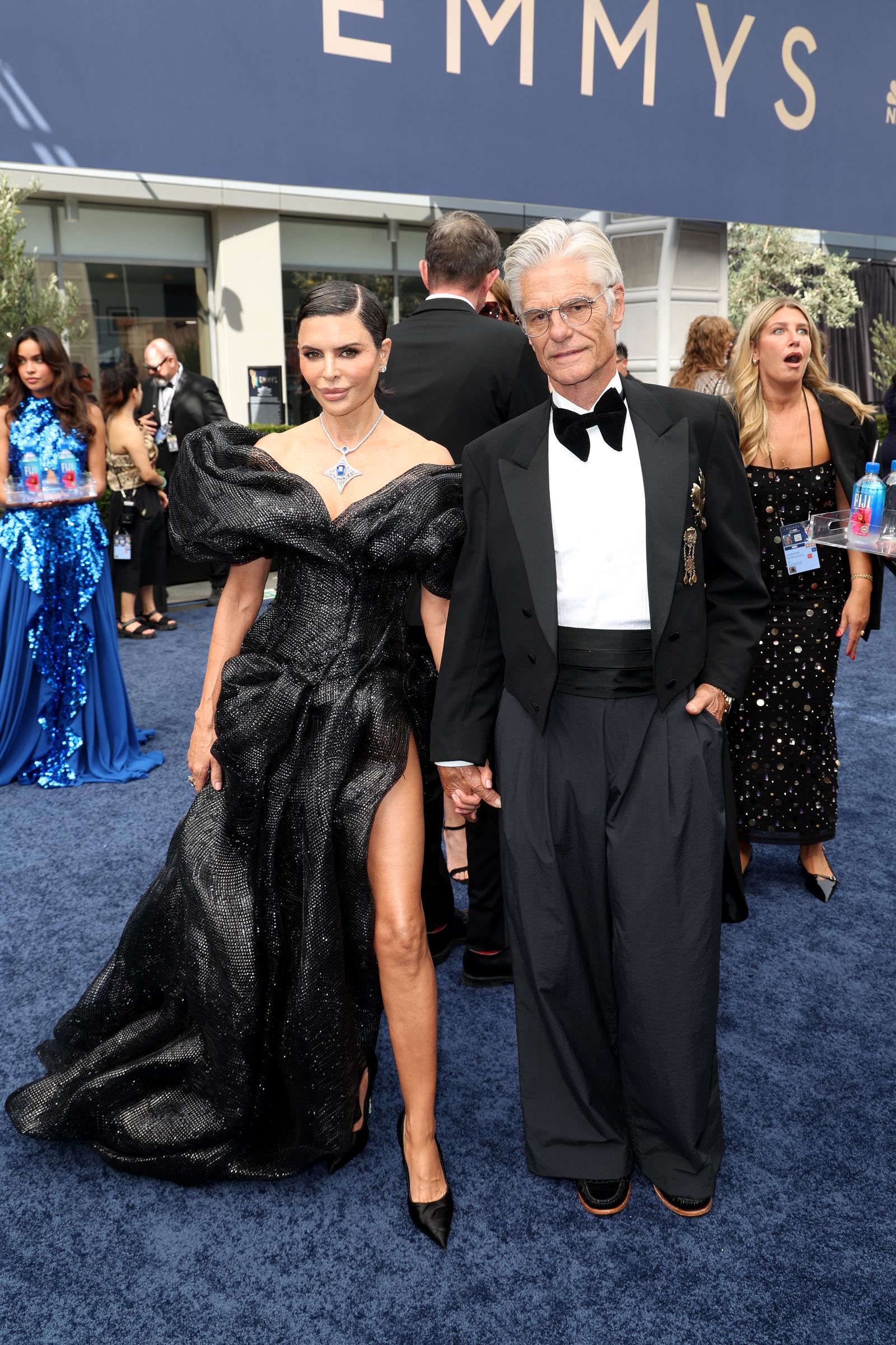 Lisa Rinna and Harry Hamlin's red-carpet appearance became one of the night's most debated fashion moments online. Viewers especially zeroed in on Hamlin's trousers, while others defended his look and praised his overall styling.