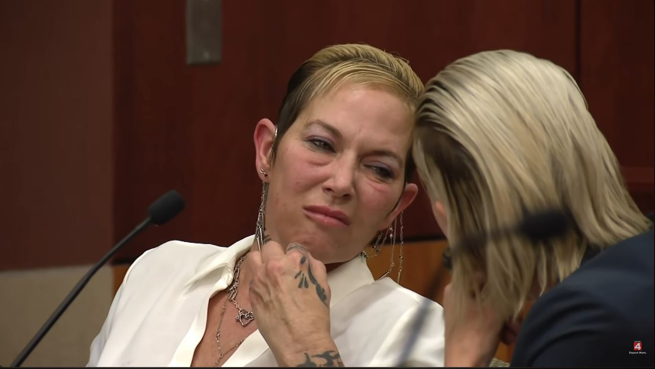 Scott turned toward her lawyer, who was seated beside her, during the court appearance, giving a closer view of the similar slicked-back hairstyles that quickly became a talking point online. Their matching looks prompted several reactions, including questions about whether the pair had shared a hairstylist before arriving in court. | Source: YouTube/Click On Detroit | Local 4 | WDIV