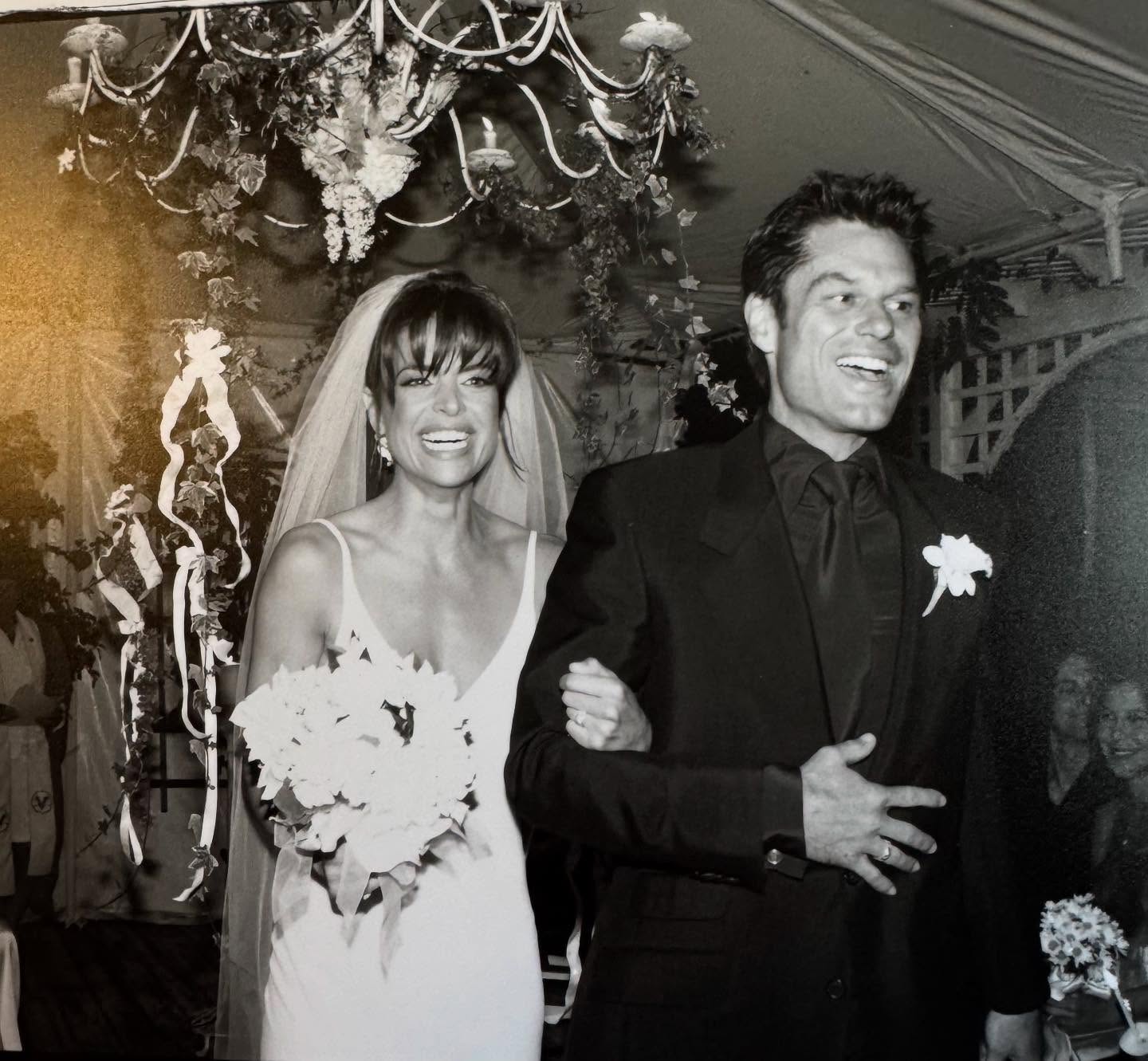 Lisa Rinna and Harry Hamlin beam as newlyweds beneath floral chandeliers hanging in their backyard. | Source: Instagram/lisarinna