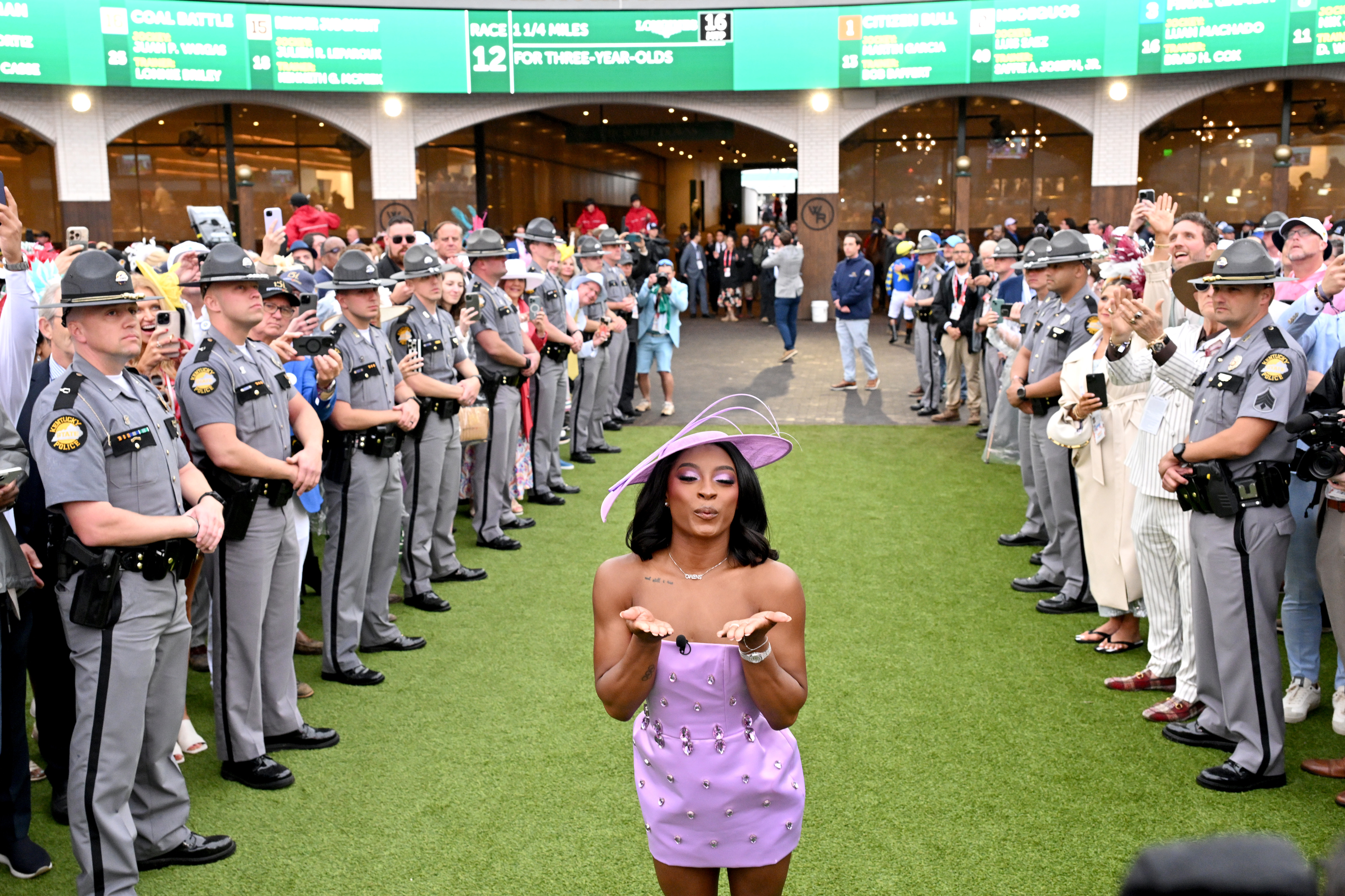 Simone Biles performing the "Riders Up" tradition and blowing a kiss. | Source: Getty Images
