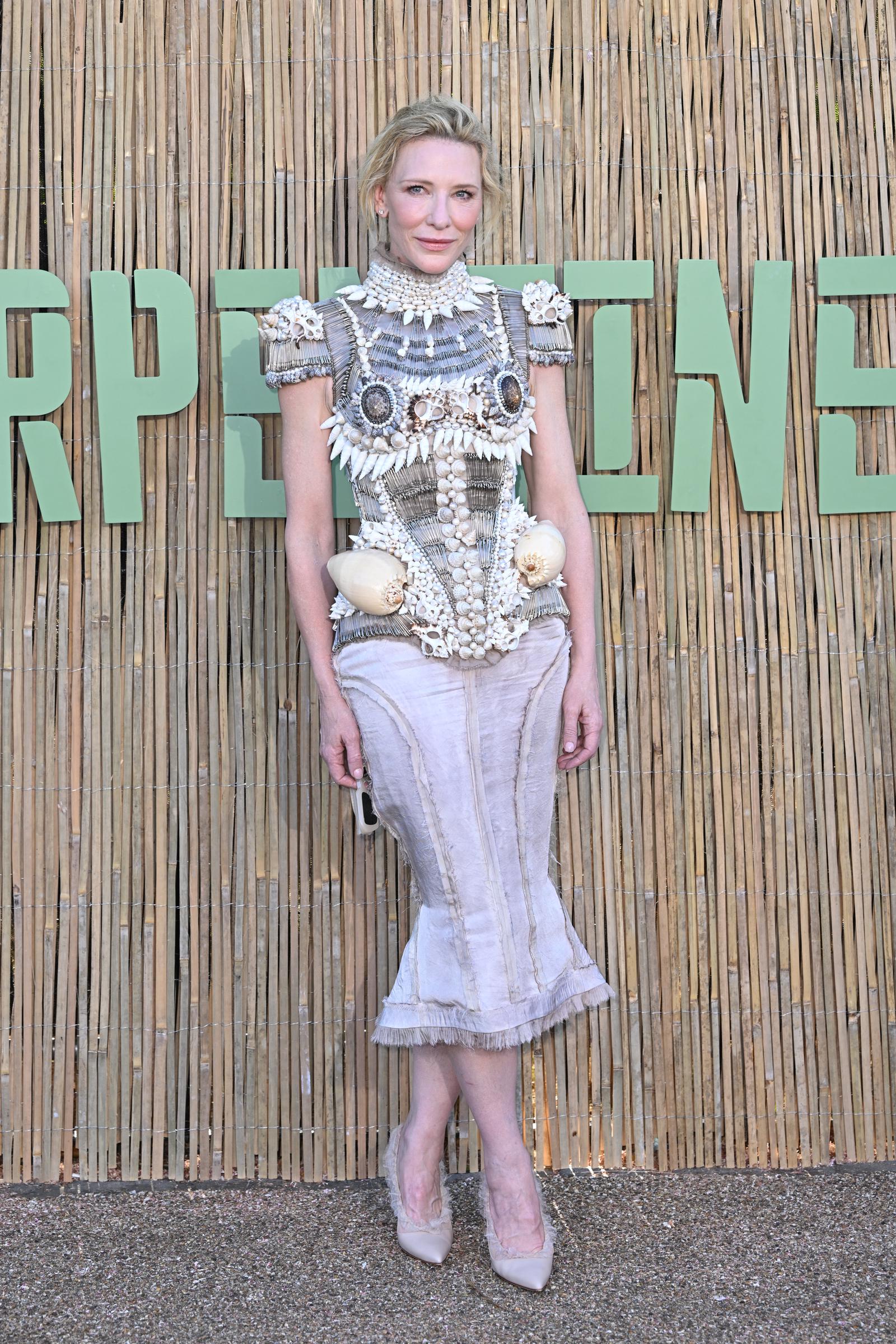 The structured outfit featured a sculptural bodice adorned with meticulously arranged seashells, beads, and layered detailing that gave it the look of wearable marine armor.