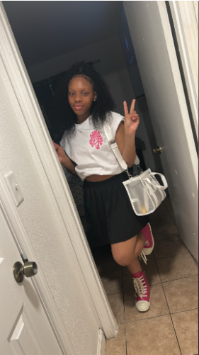 Taylor Hamilton is in a white blouse and black skirt. | Source: GoFundMe