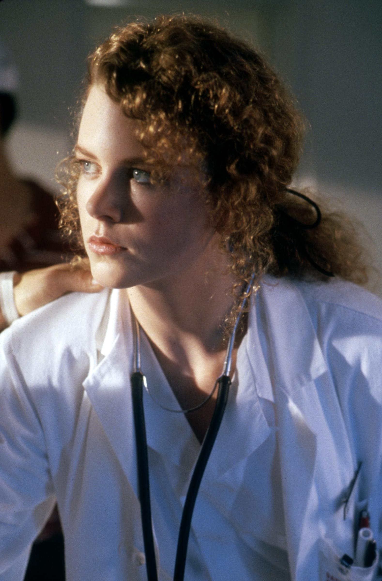 Nicole Kidman with tightly coiled red curls pulled back into a low ponytail on the set of "Days of Thunder." Her natural texture is fully visible, with soft ringlets framing her face. | Source: Getty Images