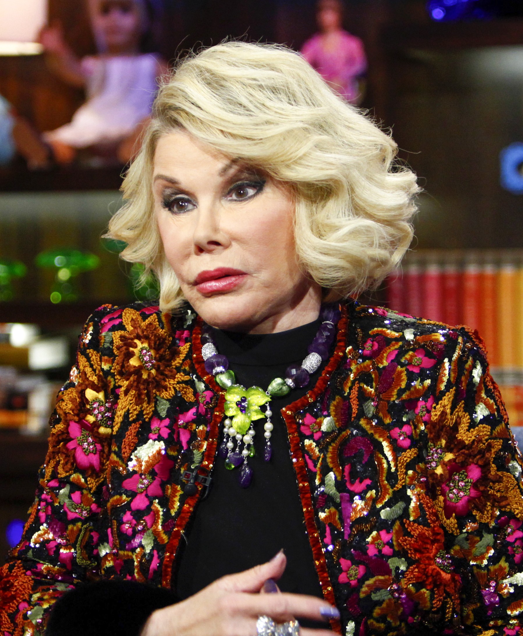 Joan wears her blonde hair in a softly layered style, with dark eye makeup, pink lipstick, and a noticeably smooth complexion. | Source: Getty Images