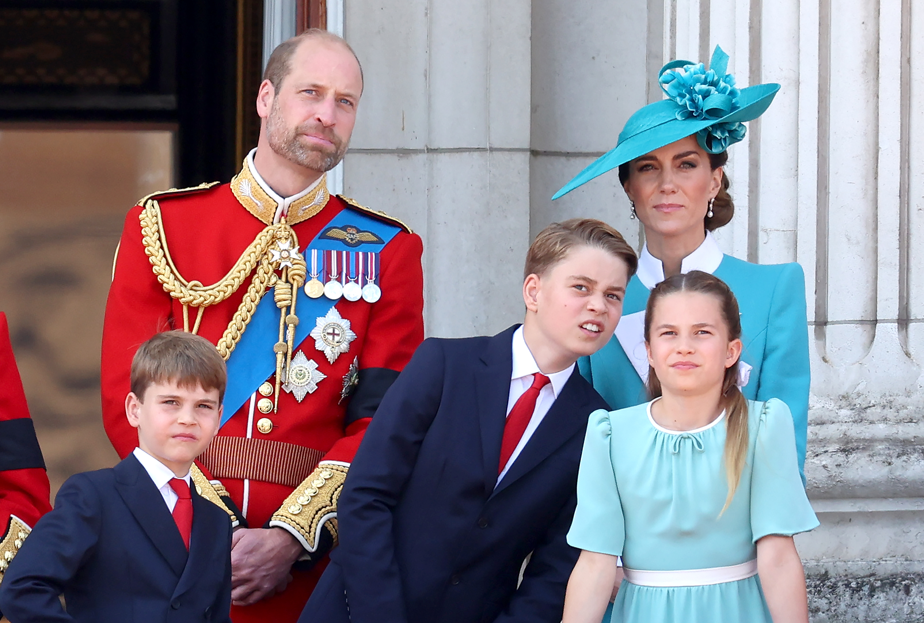 The Prince and Princess of Wales stand on the Buckingham Palace balcony during Trooping the Colour 2025, joined by their children—Prince George and Princess Charlotte. United in a display of royal tradition, the family gazes out over the cheering crowds, capturing a moment of pageantry, pride, and continuity in the heart of London.