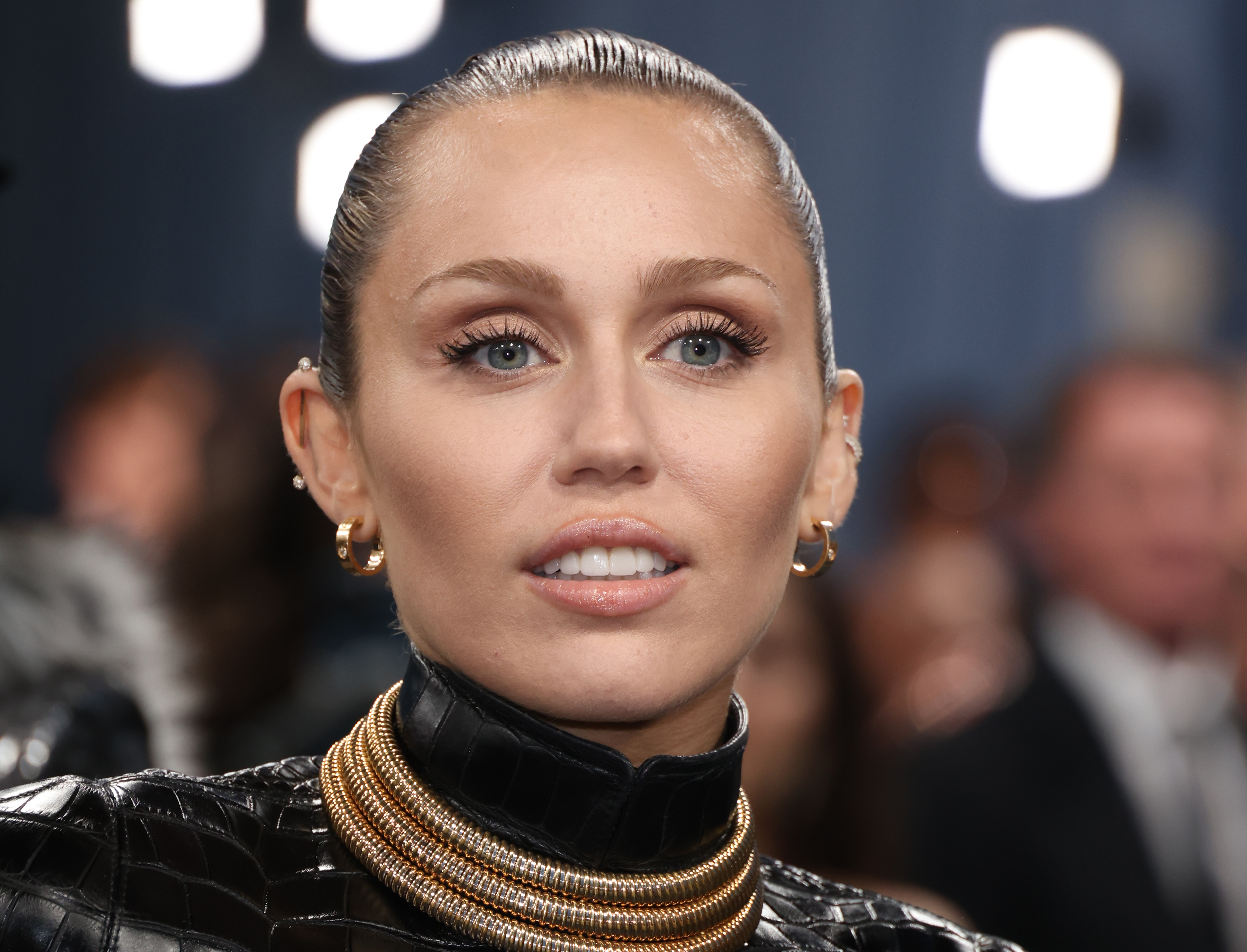 Miley Cyrus appeared with her hair slicked back and her lips slightly parted, offering a close view of her smile. Dr. Gary Linkov and Stephanie Lange discussed whether Botox around the upper lip could affect how much gum shows when someone smiles, although the photograph alone cannot establish whether she has received such injections. | Source: Getty Images