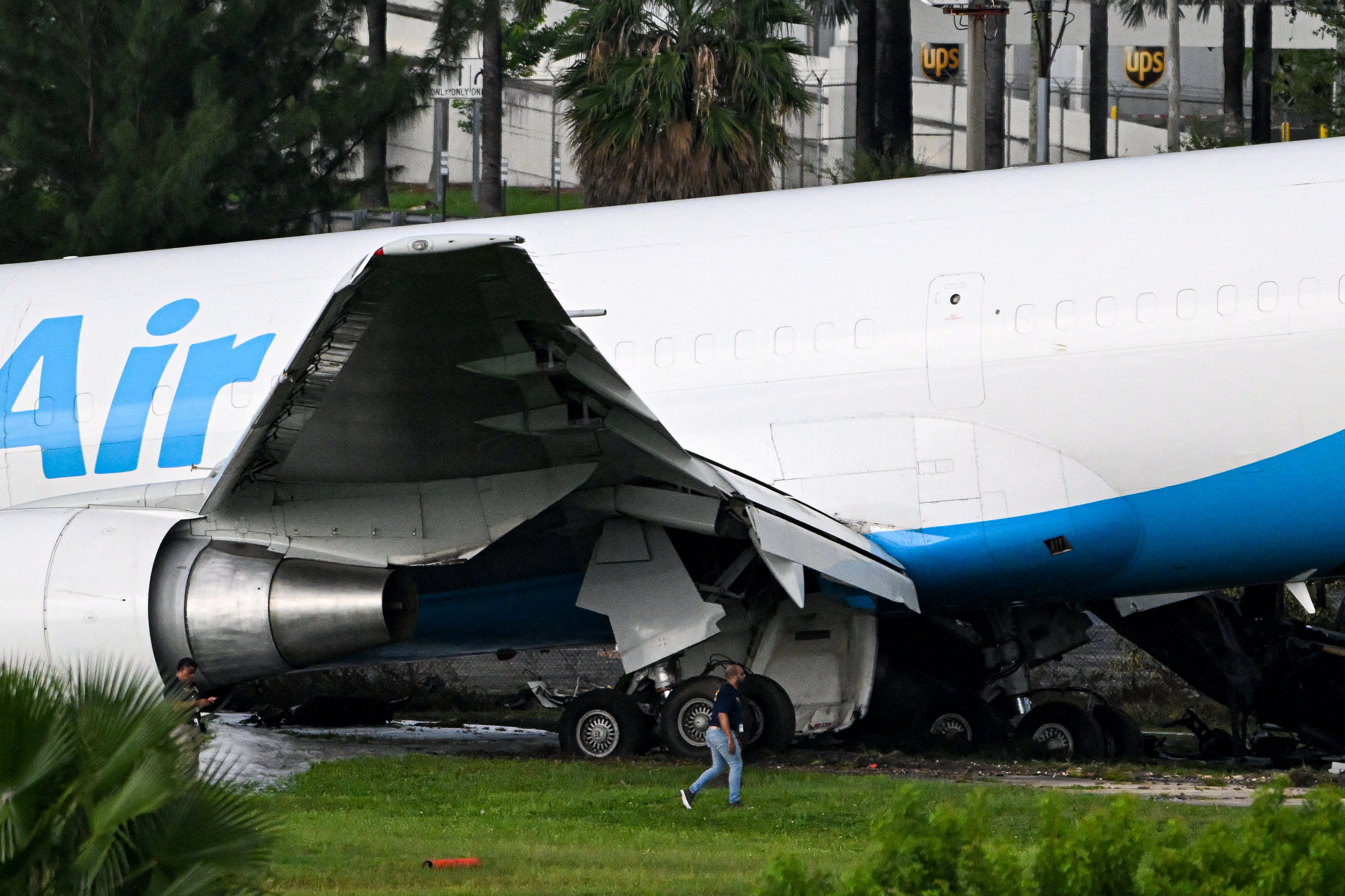 Investigators inspect the damaged wing and fuselage of the Amazon Air Boeing 767 cargo plane after it overran the runway at Miami International Airport on Sunday, September 6, 2026. | Source: Getty Images