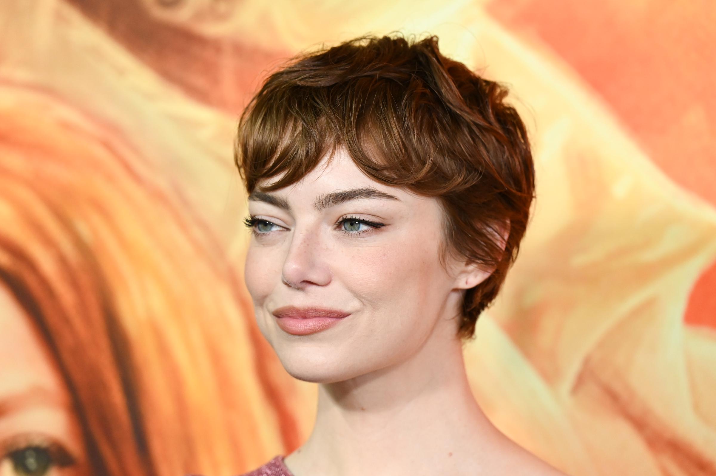 Emma Stone, with a subtle, knowing smile and a thoughtful gaze, at the "Eddington" Los Angeles Premiere held at the DGA Theater on June 26, 2025, in Los Angeles, California.