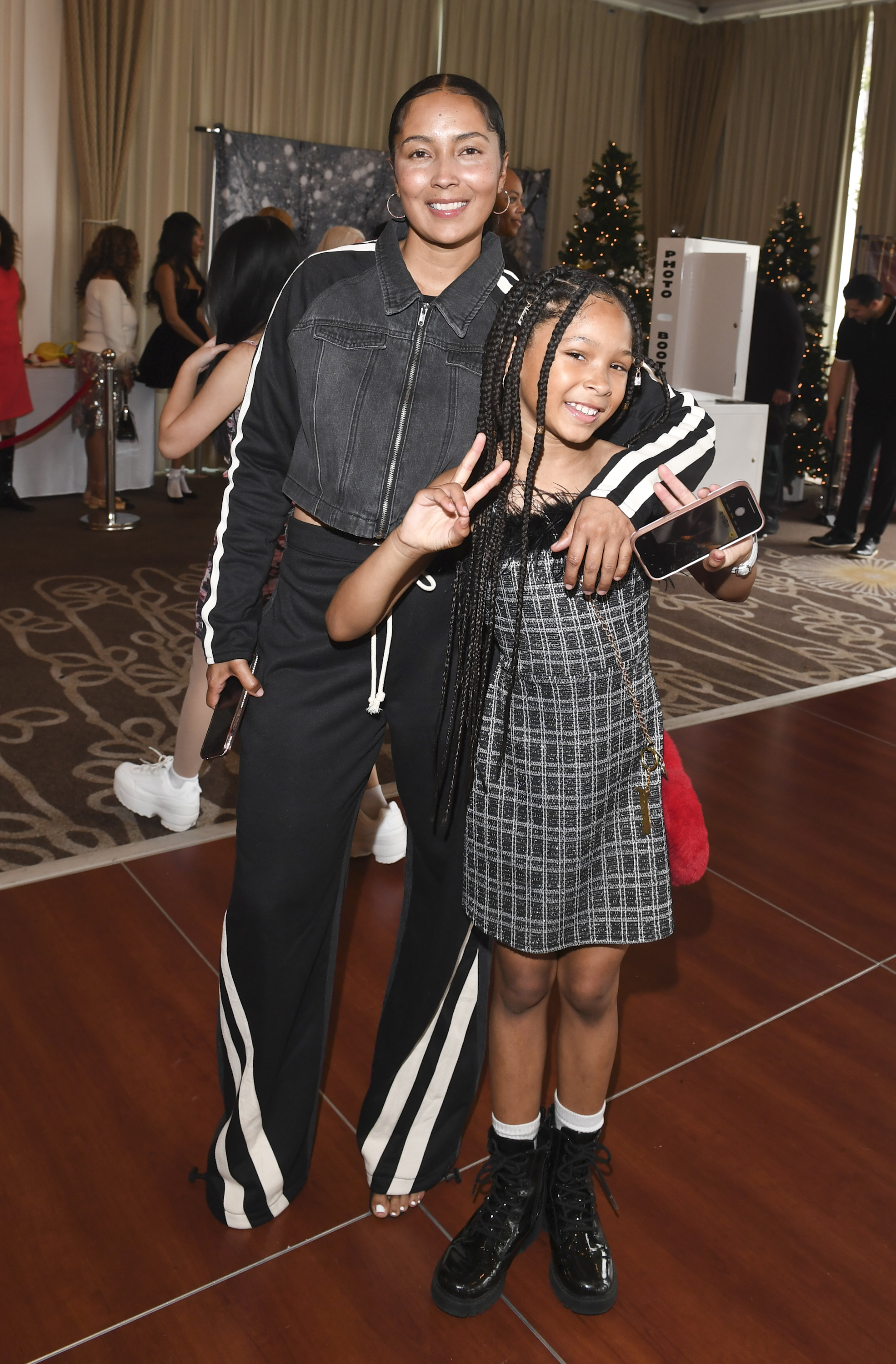 Tammy Brawner with her and Darius McCrary's daughter, Zoey McCrary, at the DBA Talent Holiday Party in Burbank, California on December 22, 2024. | Source: Getty Images