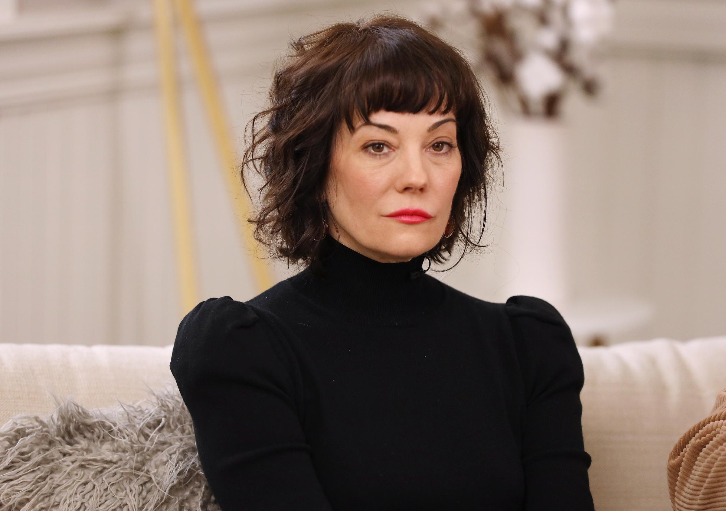 Natasha Gregson Wagner sits for a portrait at the Variety Sundance Studio presented by AT&T during the Sundance Film Festival in Park City, Utah, on January 27, 2020. She wears a black turtleneck sweater with soft curls and bold red lipstick, posing against a neutral backdrop.