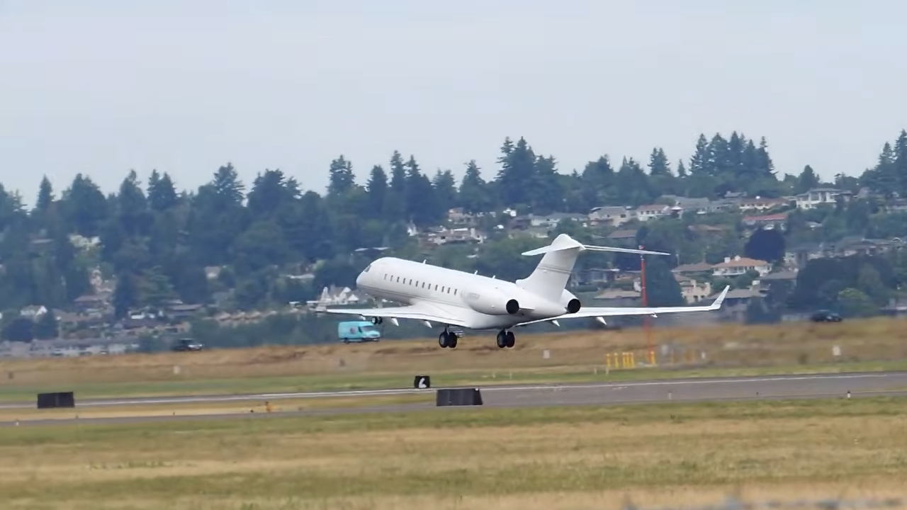A private jet ascends into the sky during takeoff over a tree-lined landscape. | Source: YouTube/@WorldOfLuxuryOfficial