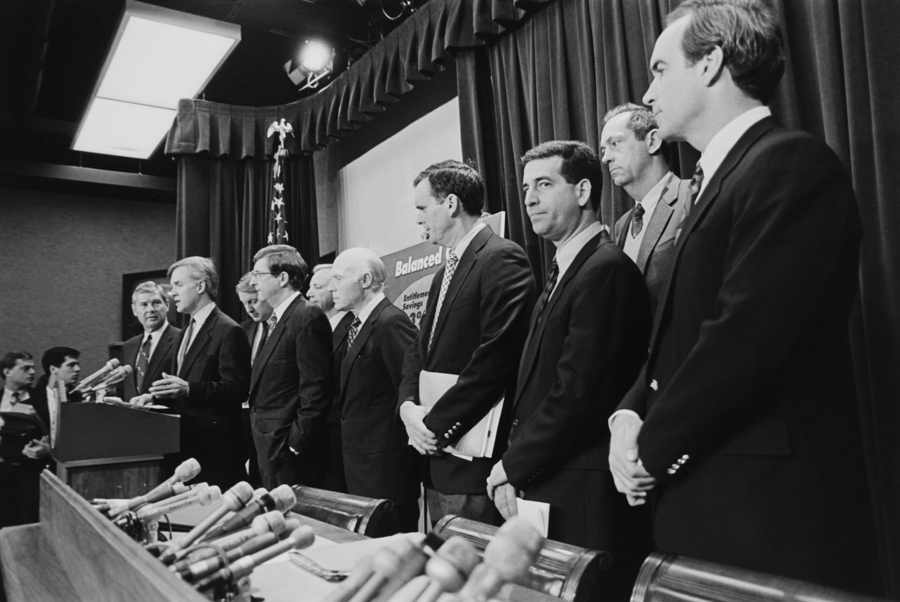 Lindsey Graham stands alongside a bipartisan group of lawmakers during a high-profile press conference on budget cuts, listening as colleagues outline their fiscal agenda. Even in the early stages of his congressional career, he was already part of major policy discussions in Washington. | Source: Getty Images