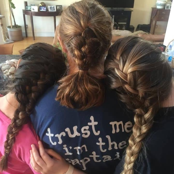 A happy mother-and-daughters moment captures the three sharing a warm embrace at home, a touching glimpse of their family life together. | Source: Facebook/@katie.mannix.5